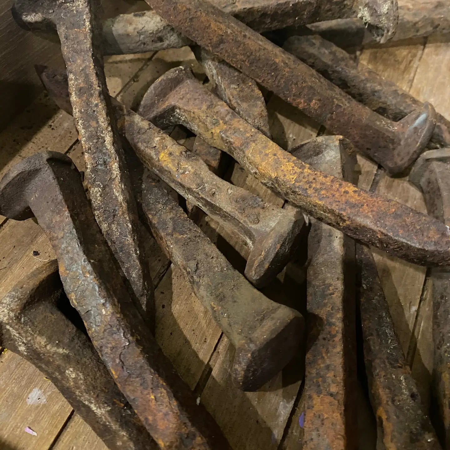 A pile of rusty rail road spikes